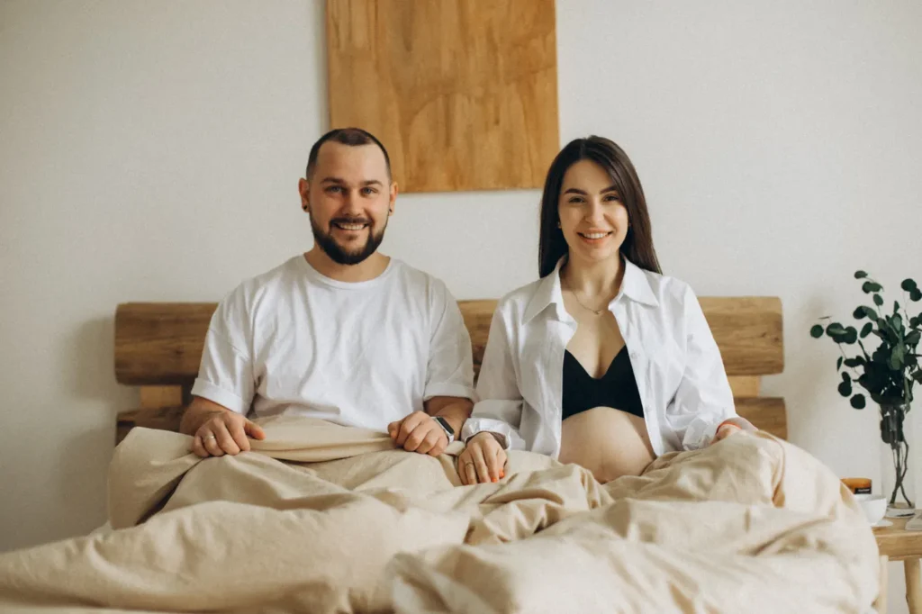 Couple sitting on a newly made bed