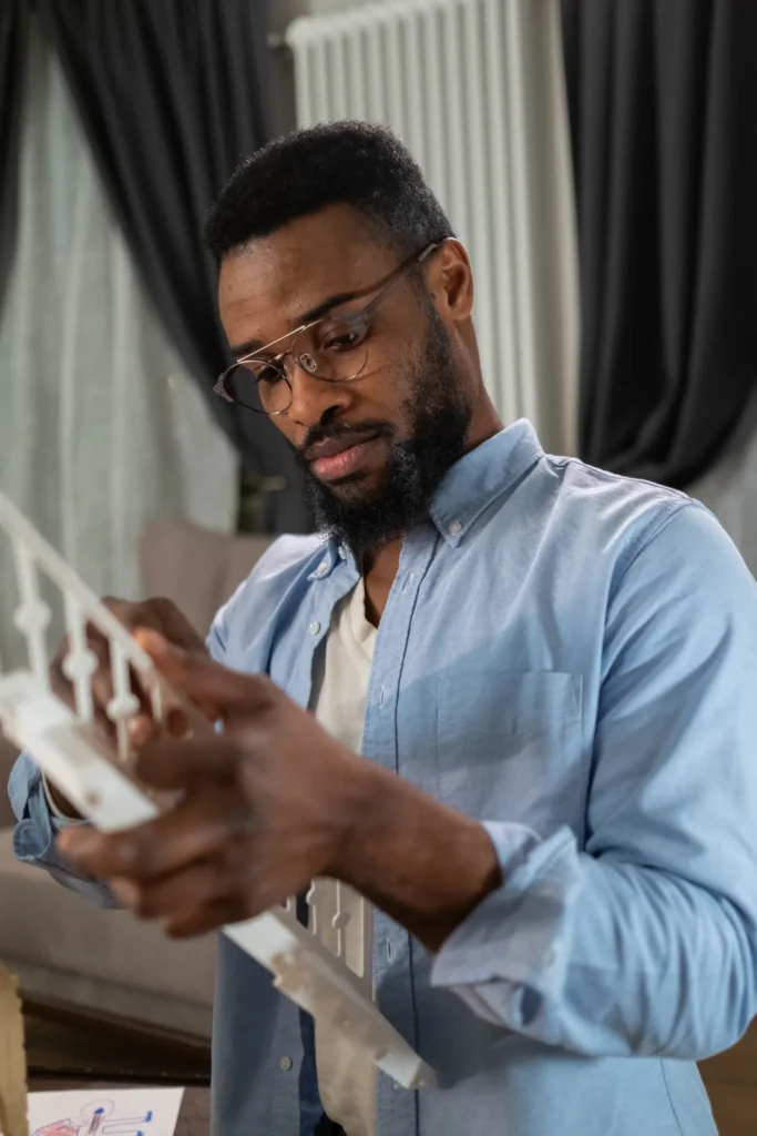 Man reading furniture assembly instructions