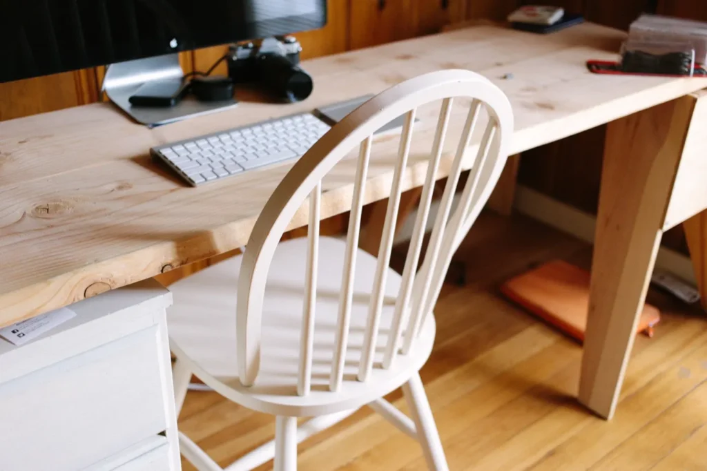Wooden desk with a white chair in a home office