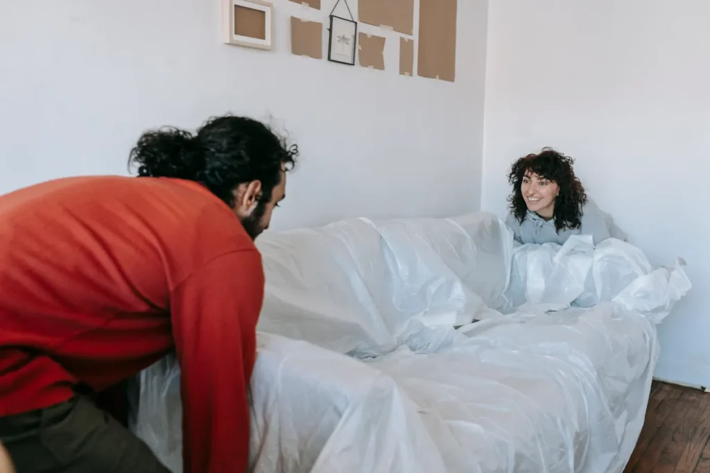 Man wrapping furniture for a move