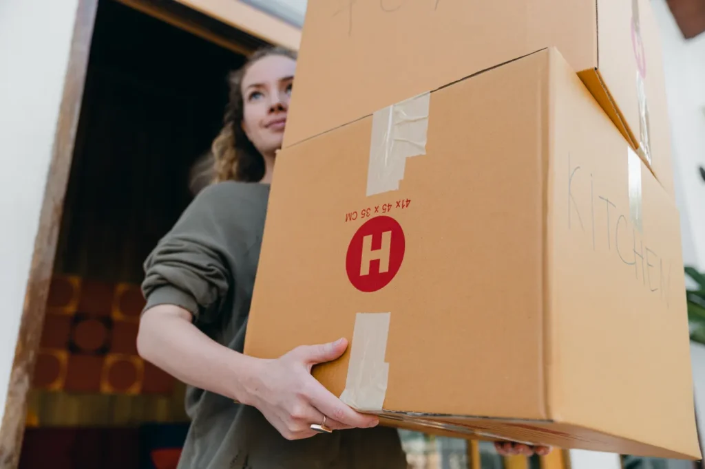 Woman carrying a moving box