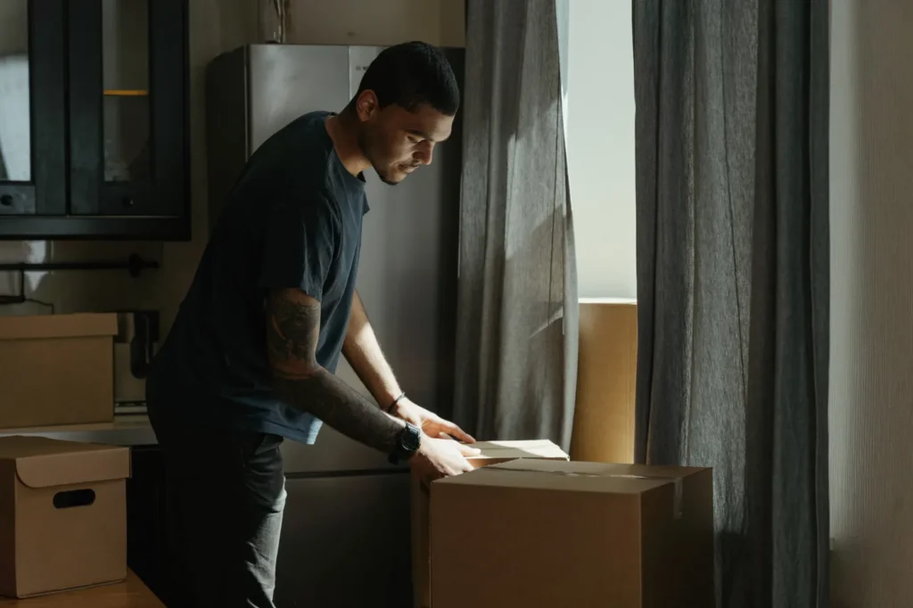 Man packing boxes in an apartment