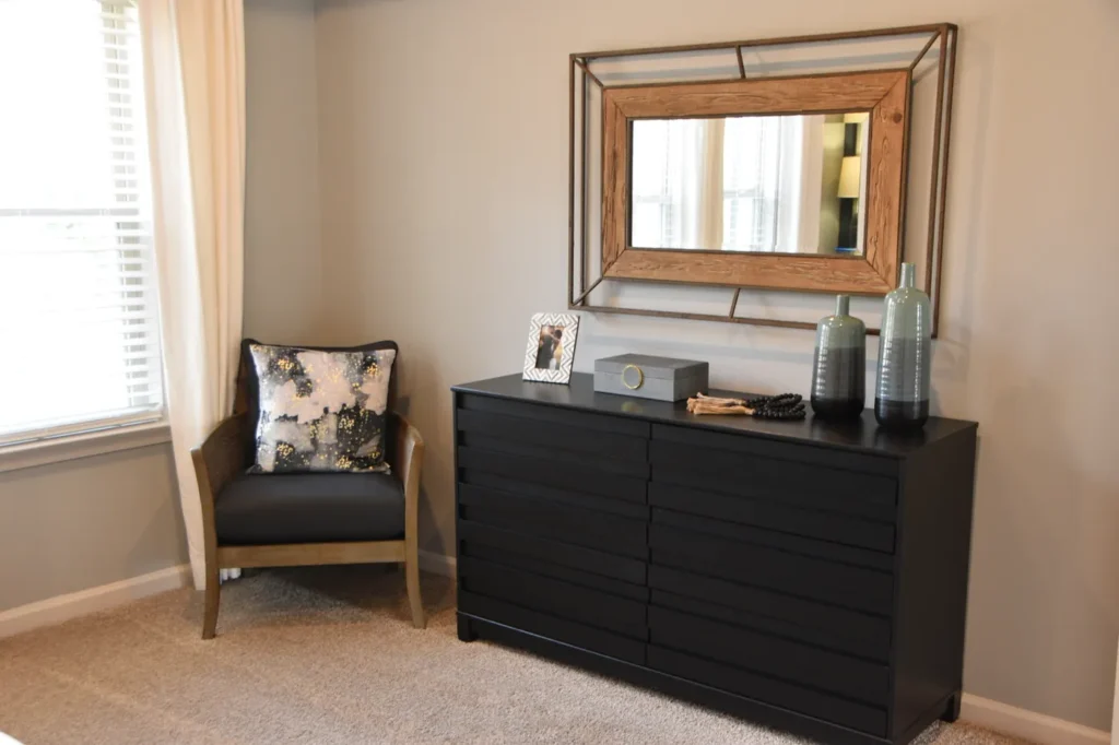 Dresser with a mirror above it in a bedroom