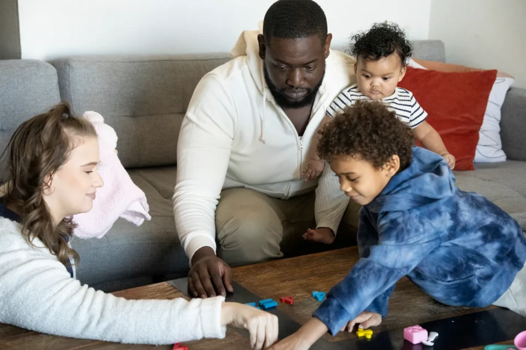 Family playing together on the living room floor