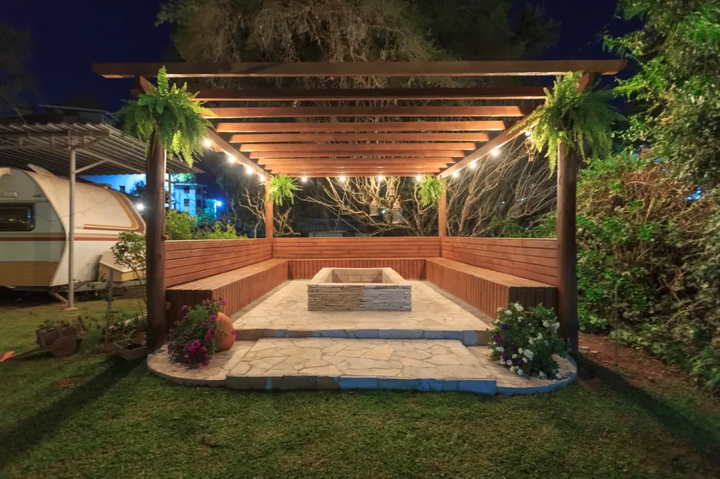 Pergola lit with string lights at dusk