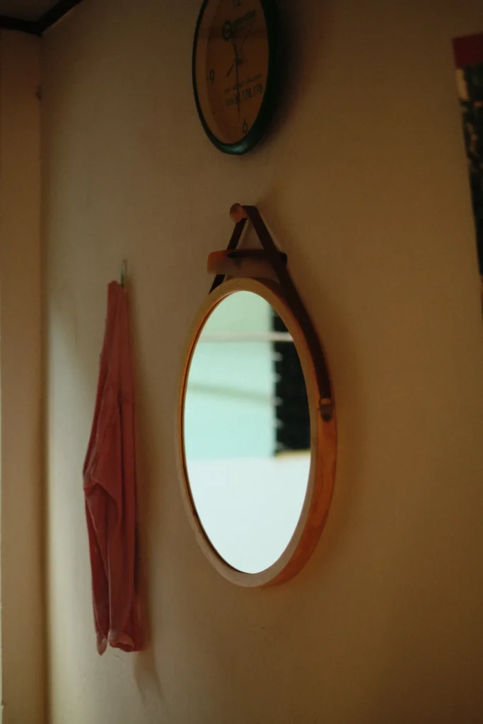 Oval wall mirror in a warm-toned room