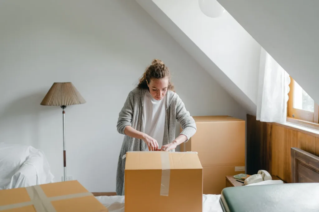 Woman packing boxes in an empty room