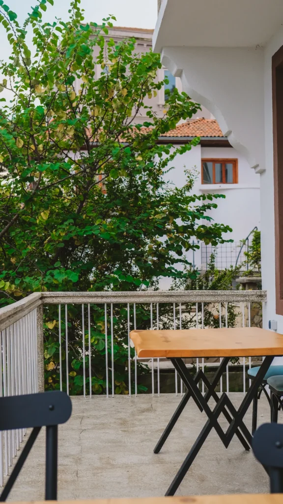 Small balcony table and chairs among plants
