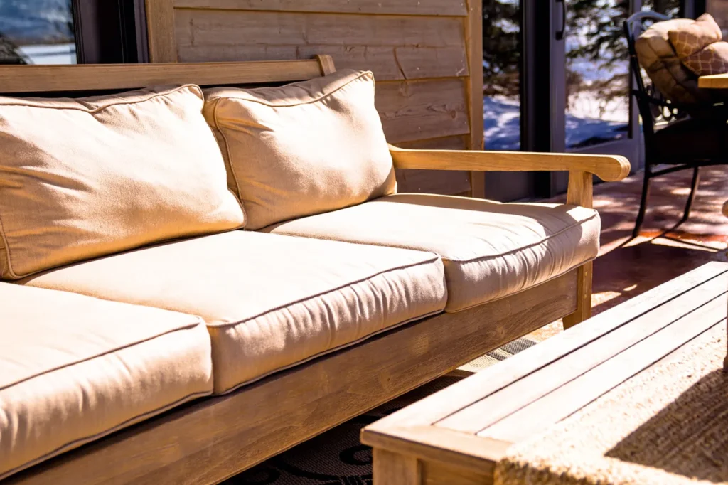 Cushioned wooden sofa on an outdoor patio