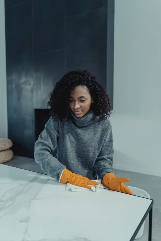 Woman wiping down a table at home
