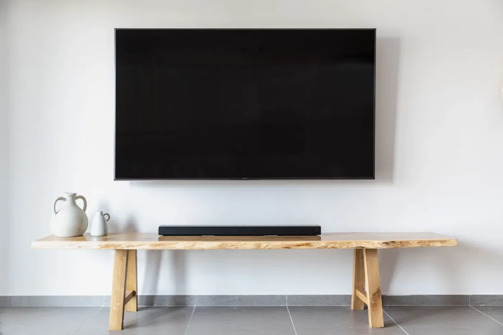 Flat-screen TV mounted above a wooden console