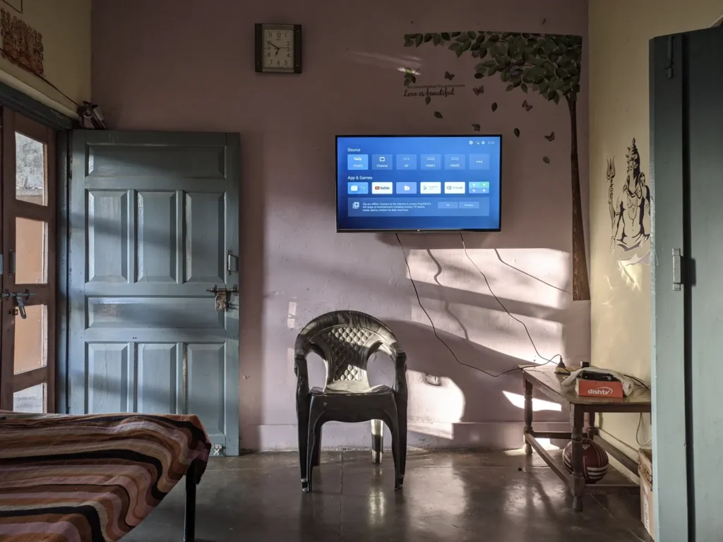 TV mounted on a living room wall beside a doorway