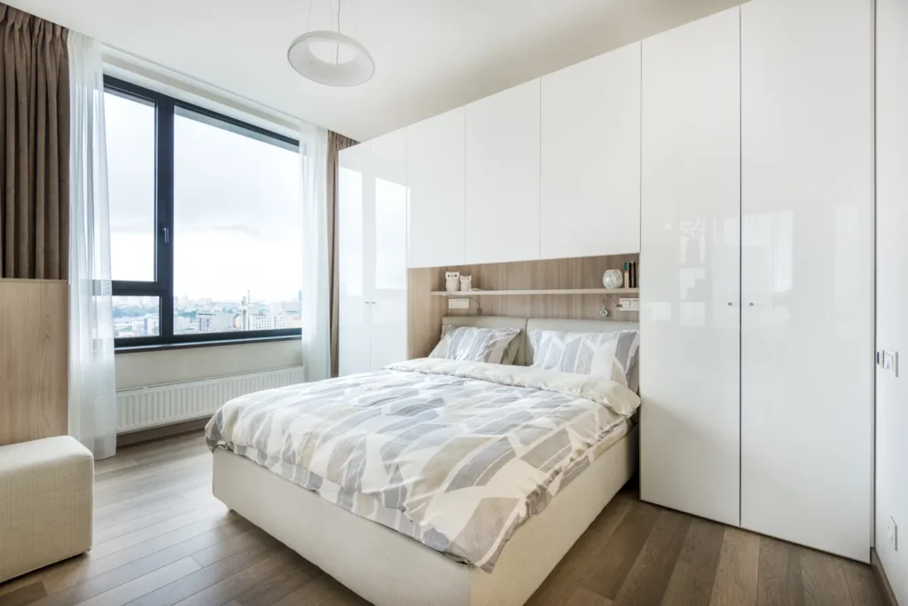 Wardrobe with doors around a bed in a bedroom